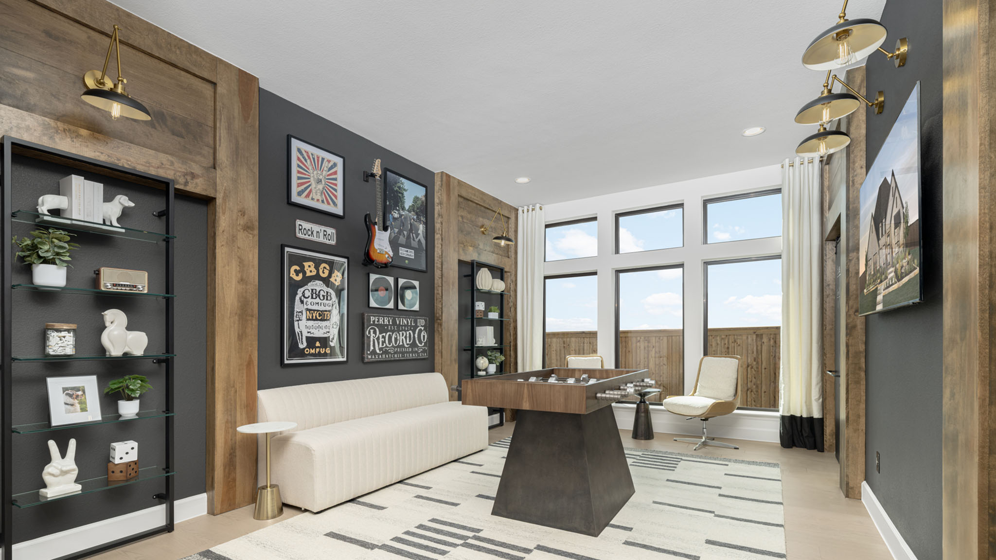 Game room with foosball table, music-themed gallery wall, and glass display shelves.